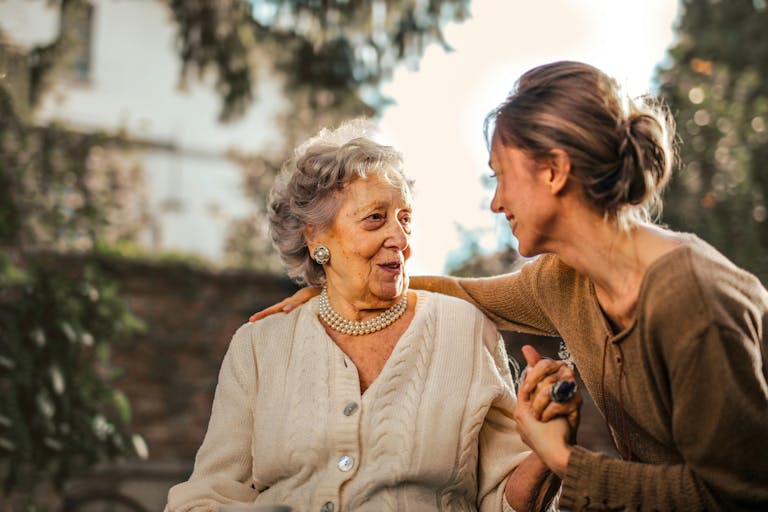 Elderly woman smiling with caregiver